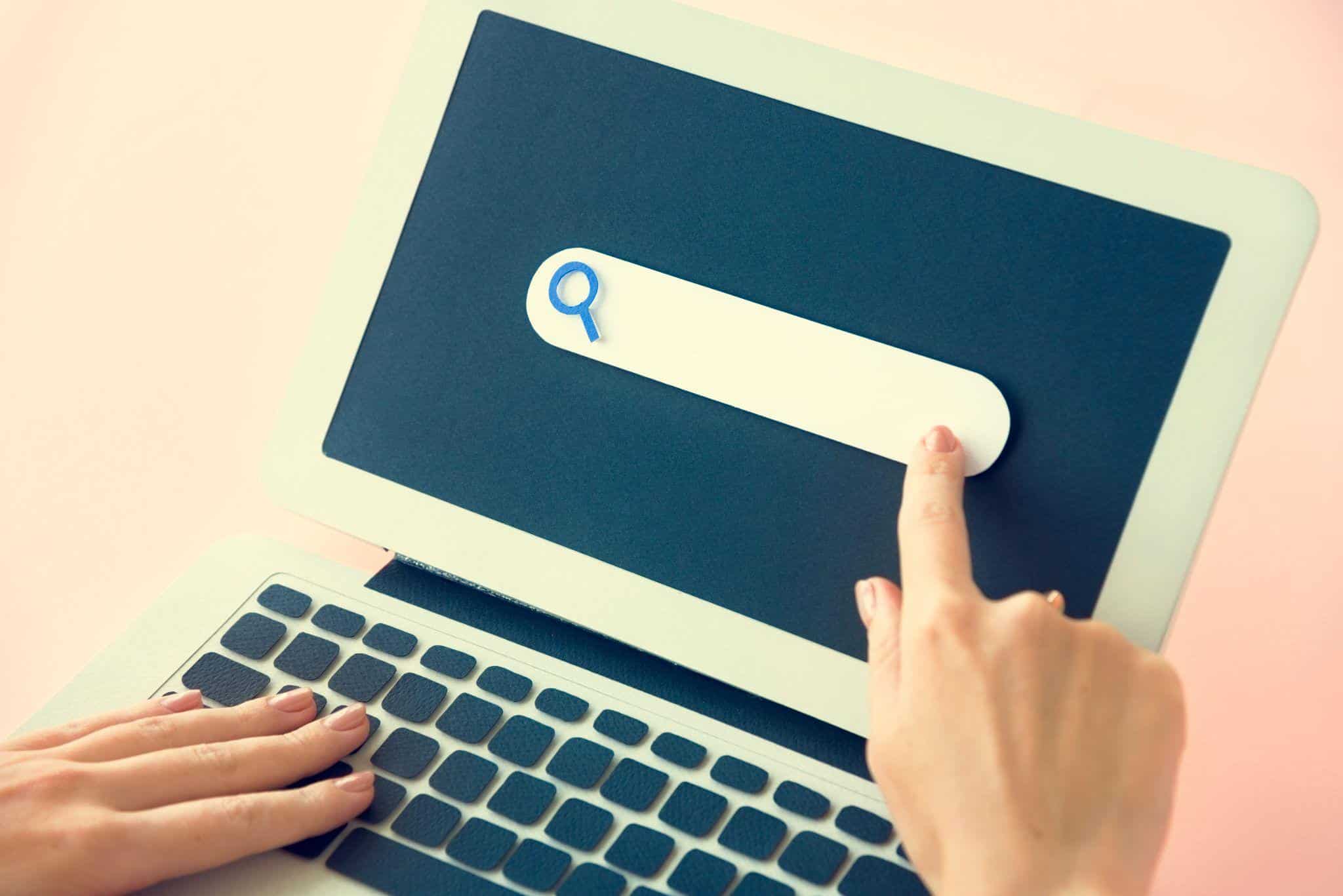 paper cutout of search engine on laptop