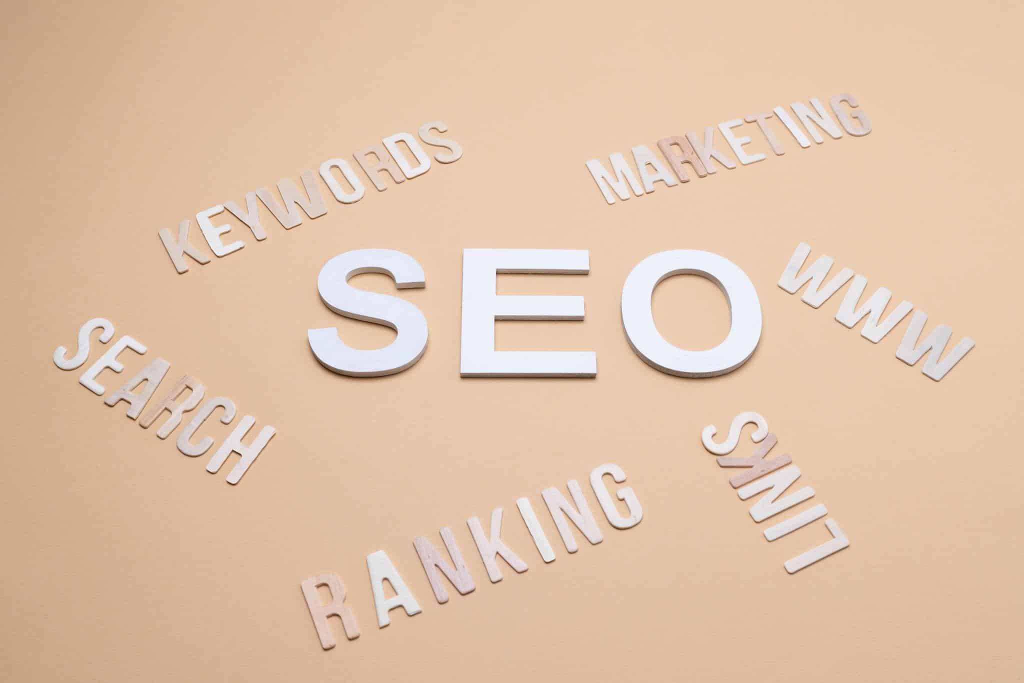 words related to SEO, such as search, keywords, ranking, and links, on a brown surface
