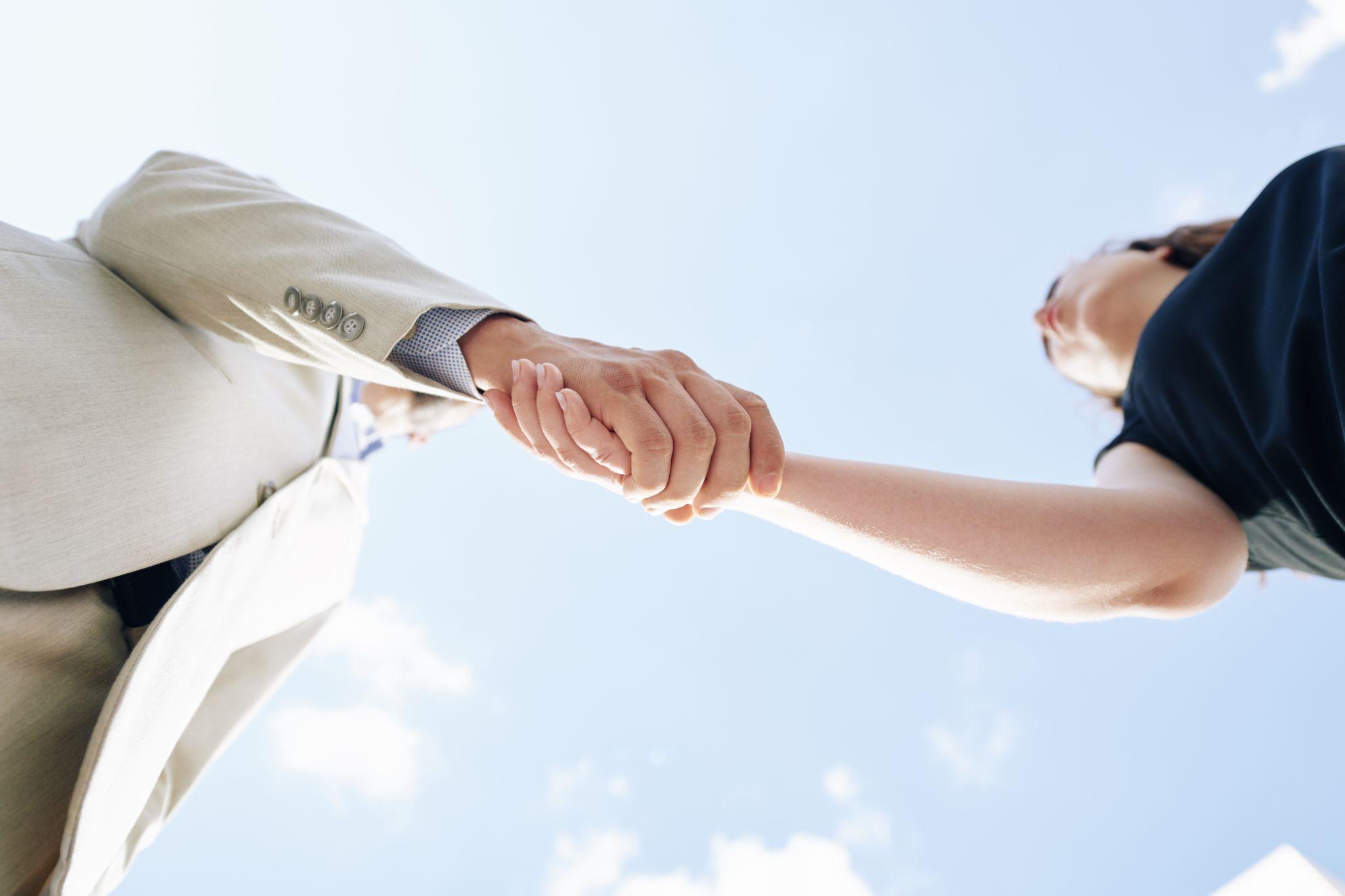 two people shaking hands, representing business trust