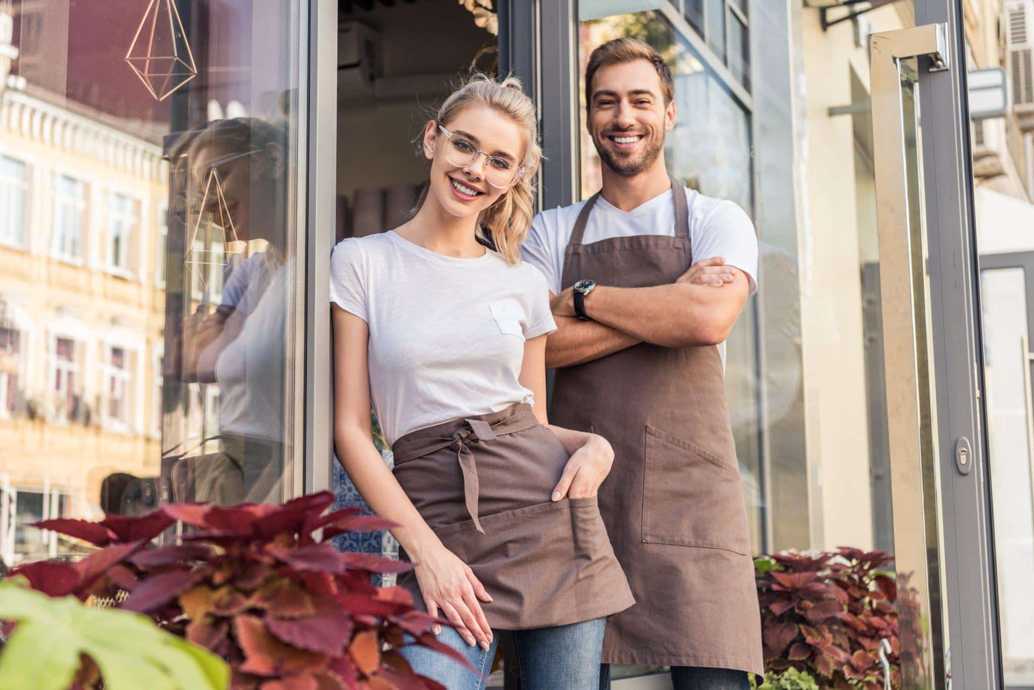 two people in front of a local shop
