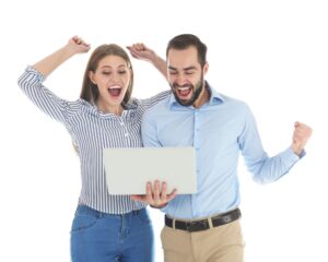Excited couple celebrating success from search engine optimization results on a laptop